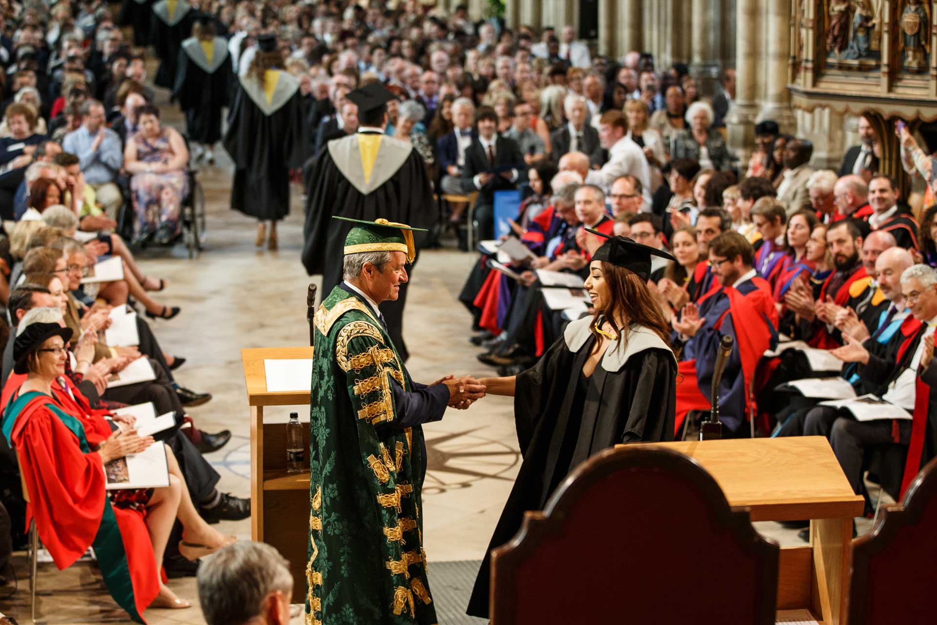 Gavin Esler giving award at graduation ceremony in Canterbury Cathedral