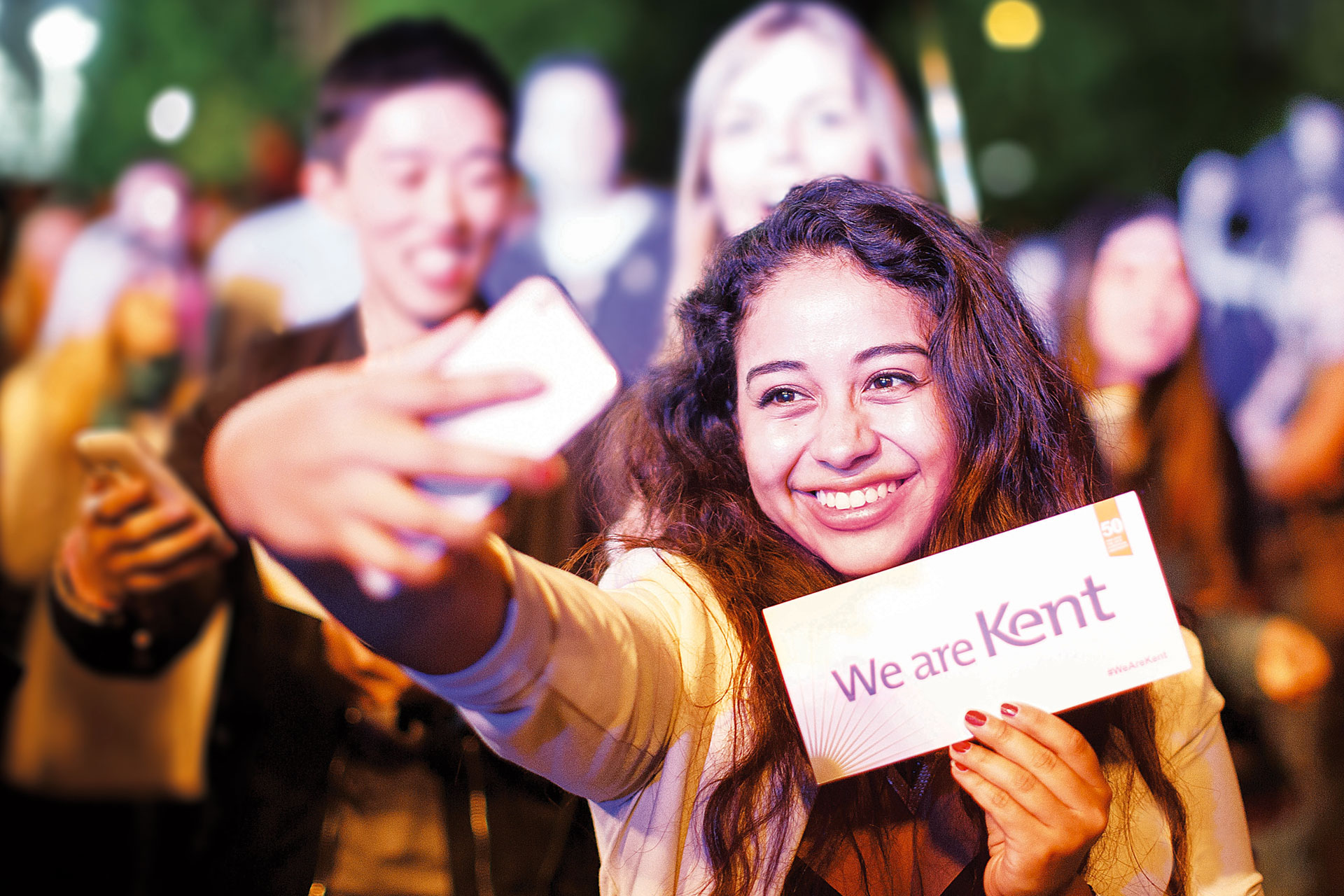 Student taking a selfie holding a We are Kent